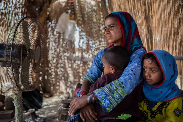 A mother with her two children at home